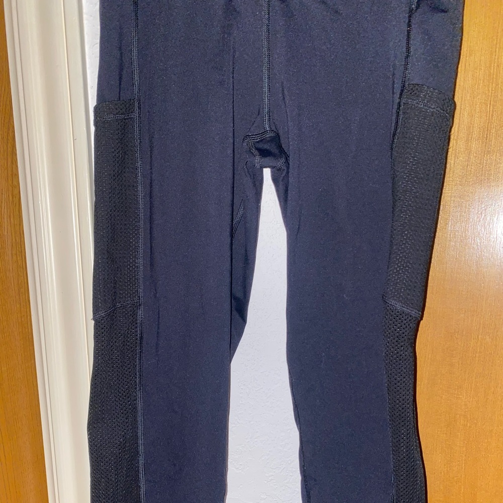 Black Aerie leggings with see through pattern on both sides of the legs